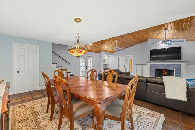 a dining room with furniture a rug and wooden floor