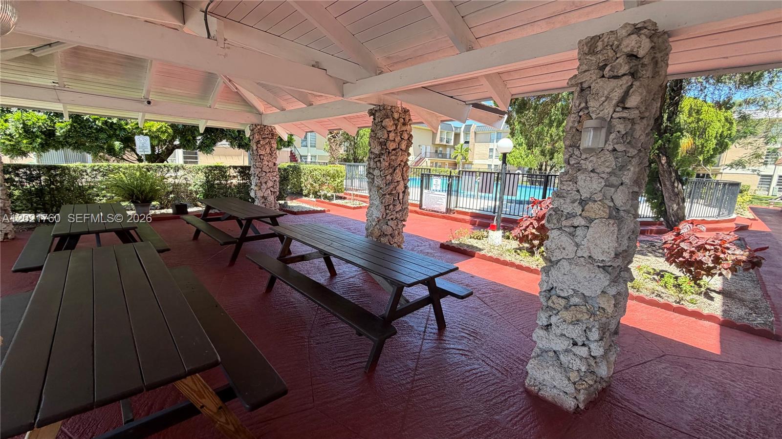 3901 Southwest 109th Avenue, Unit 4 Miami, FL 33165 - Photo 1 of 15 a building outdoor space with patio furniture and potted plants