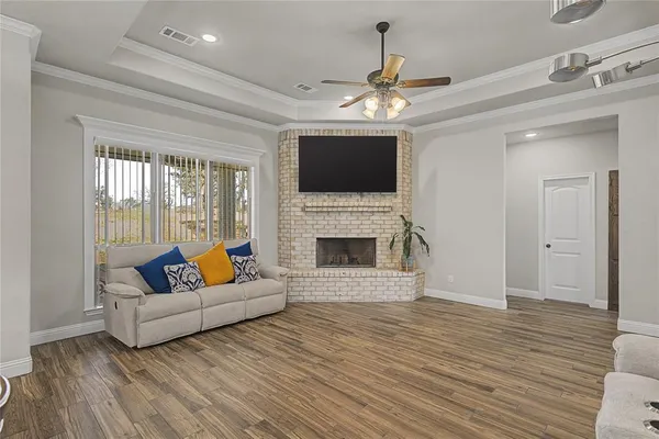 a living room with furniture a fireplace and a flat screen tv