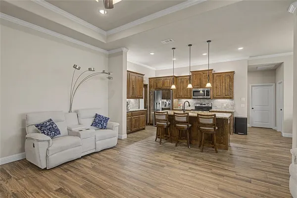 a living room with furniture and kitchen view