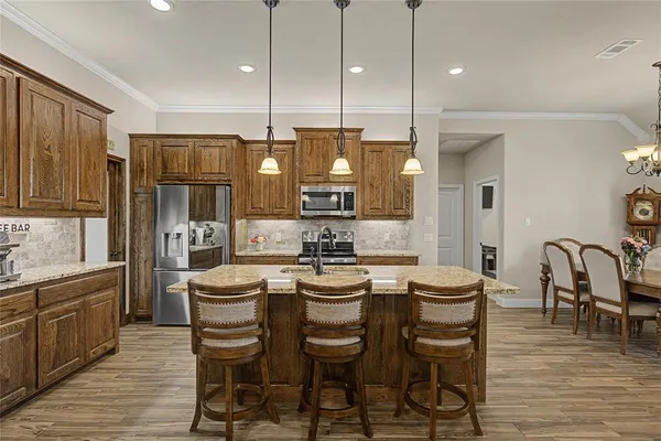 a large kitchen with a table and chairs