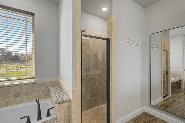 a bathroom with a shower and a tub
