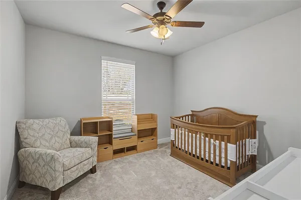 a bedroom with furniture and a ceiling fan