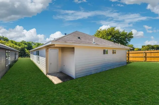 a view of a backyard with plants and a garden