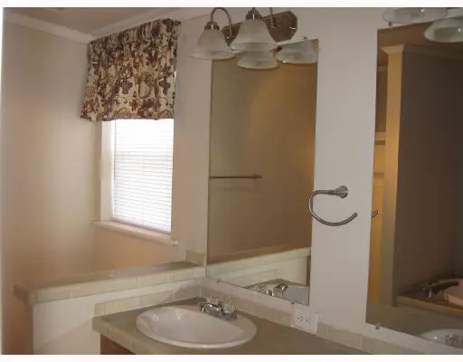 a bathroom with a window and a chandelier
