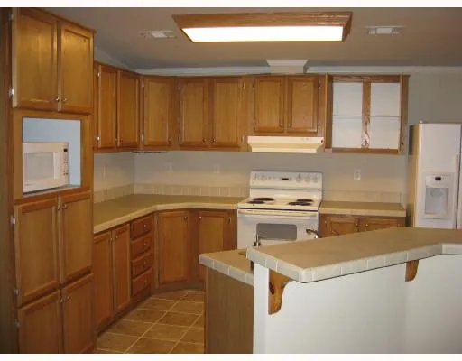 a view of a backyard with wooden fence