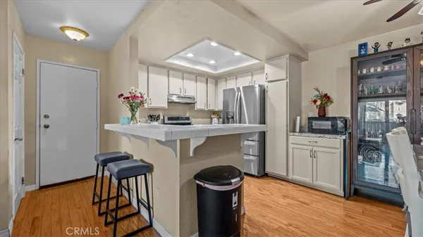 a kitchen with white cabinets and appliances