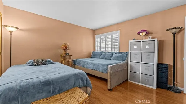 a bedroom with two beds and a window