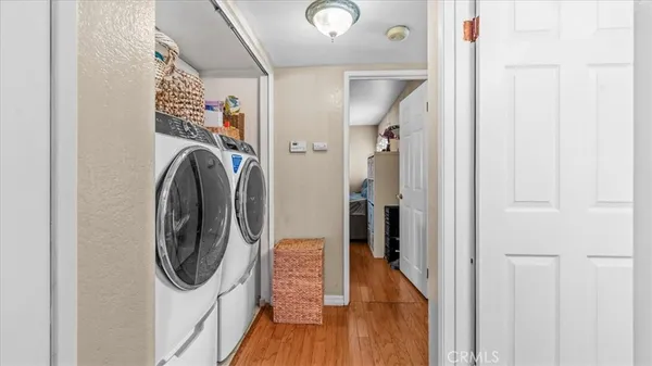 a view of a hallway with washer and dryer