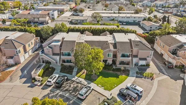 an aerial view of multiple houses with yard