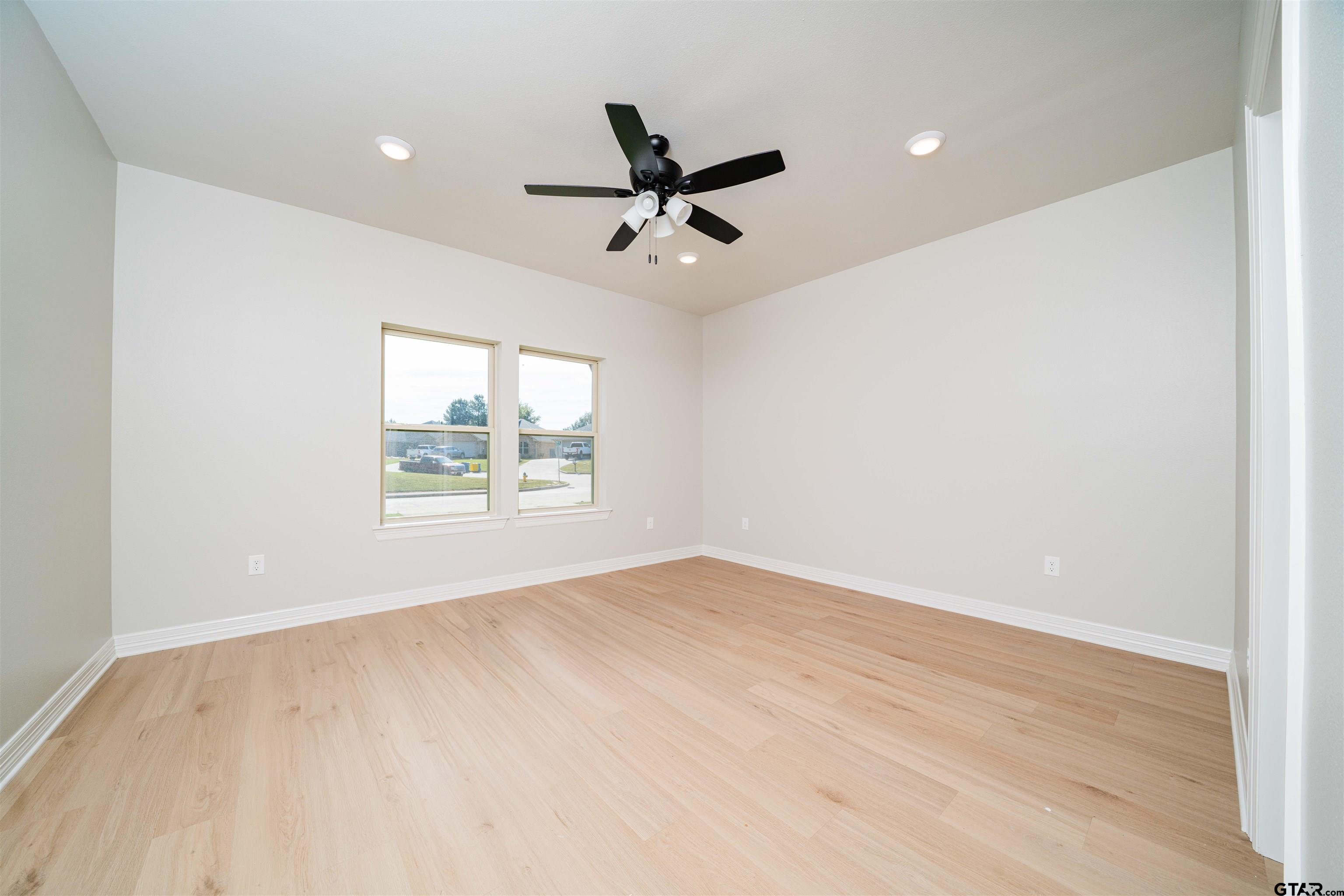 1203 Penny Lane Kilgore, TX 75662 - Photo 12 of 24 wooden floor in an empty room with a window