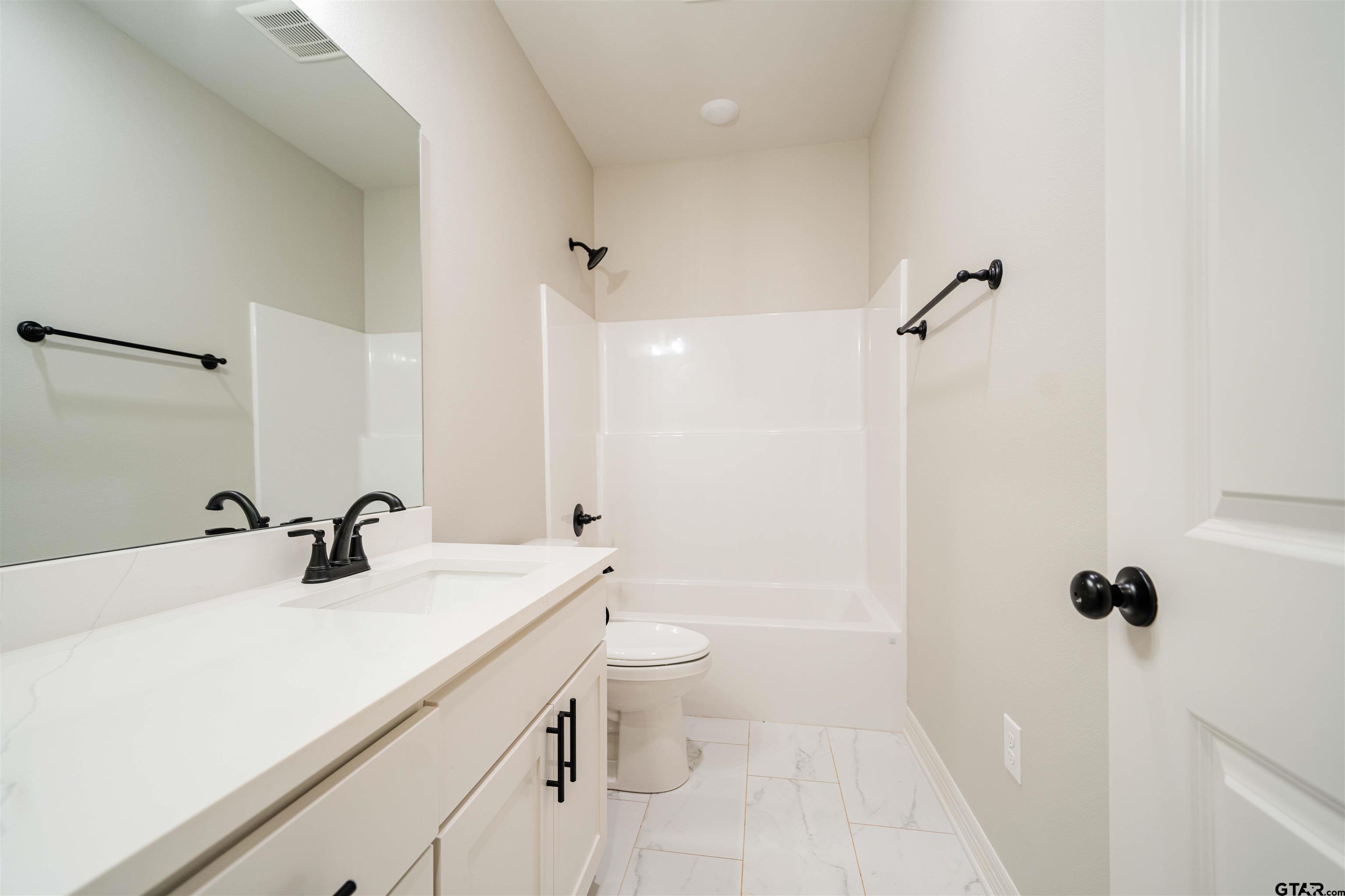1203 Penny Lane Kilgore, TX 75662 - Photo 20 of 24 a bathroom with a sink a toilet and shower