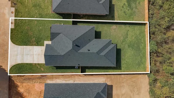 an aerial view of a house with a yard