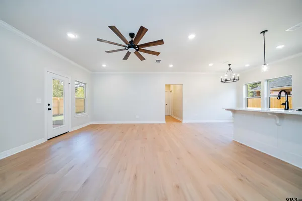 a view of a livingroom with a hardwood floor and a ceiling fan