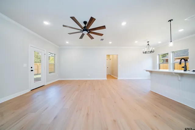 a view of a livingroom with a hardwood floor and a ceiling fan