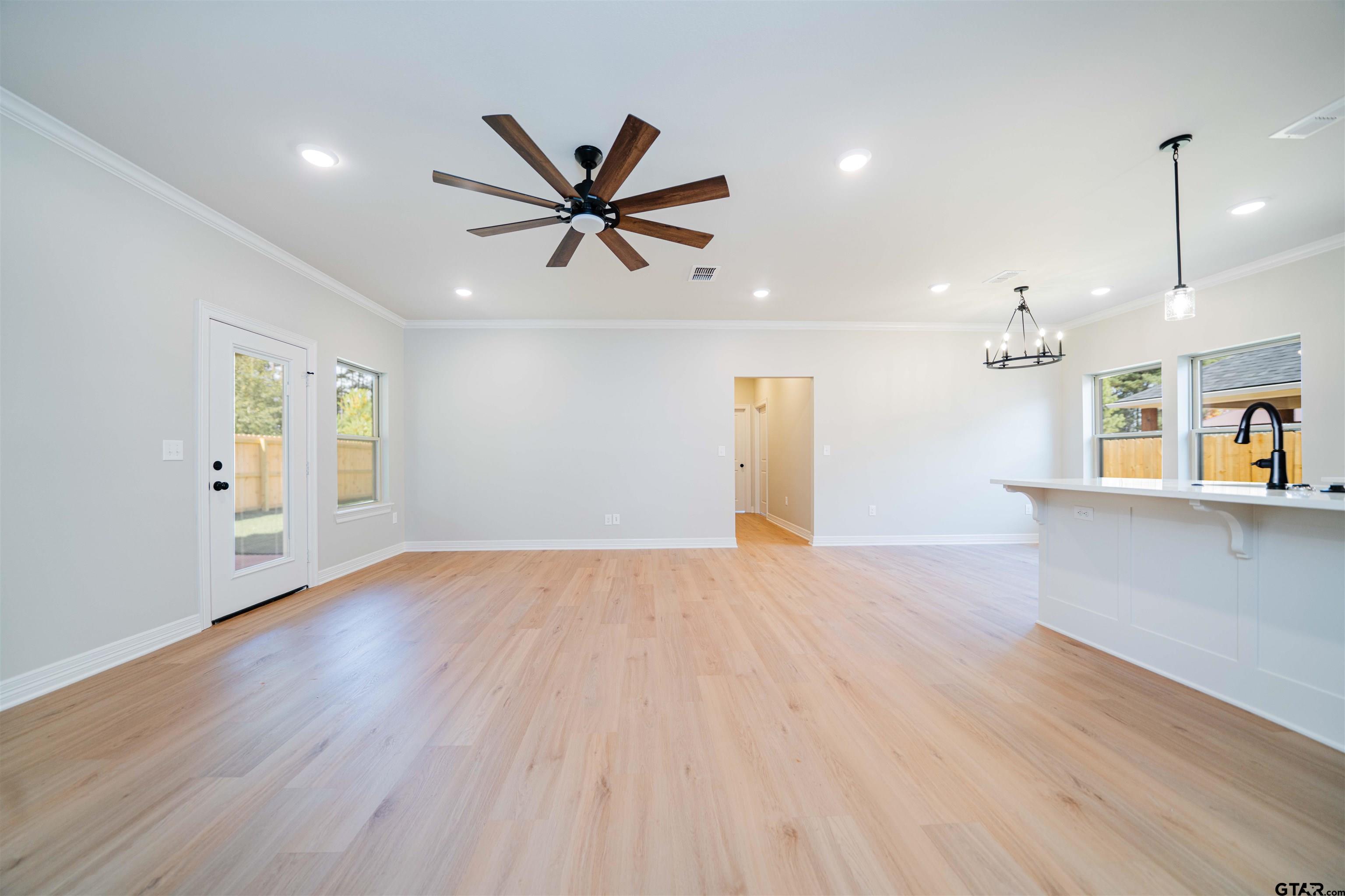 1203 Penny Lane Kilgore, TX 75662 - Photo 3 of 24 a view of a livingroom with a hardwood floor and a ceiling fan