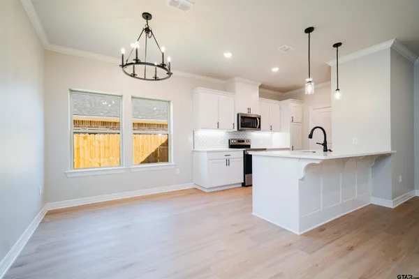 a kitchen with refrigerator and window