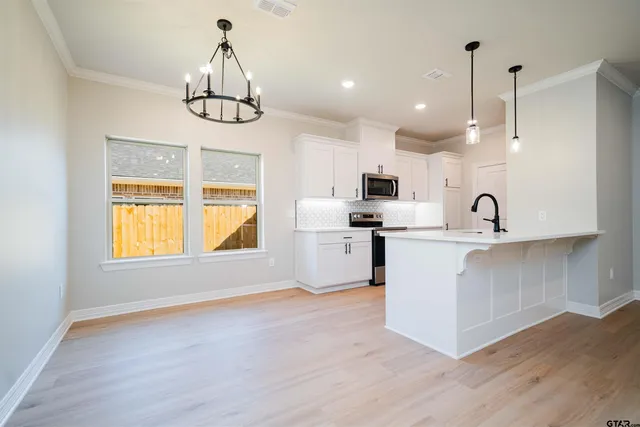 a kitchen with refrigerator and window