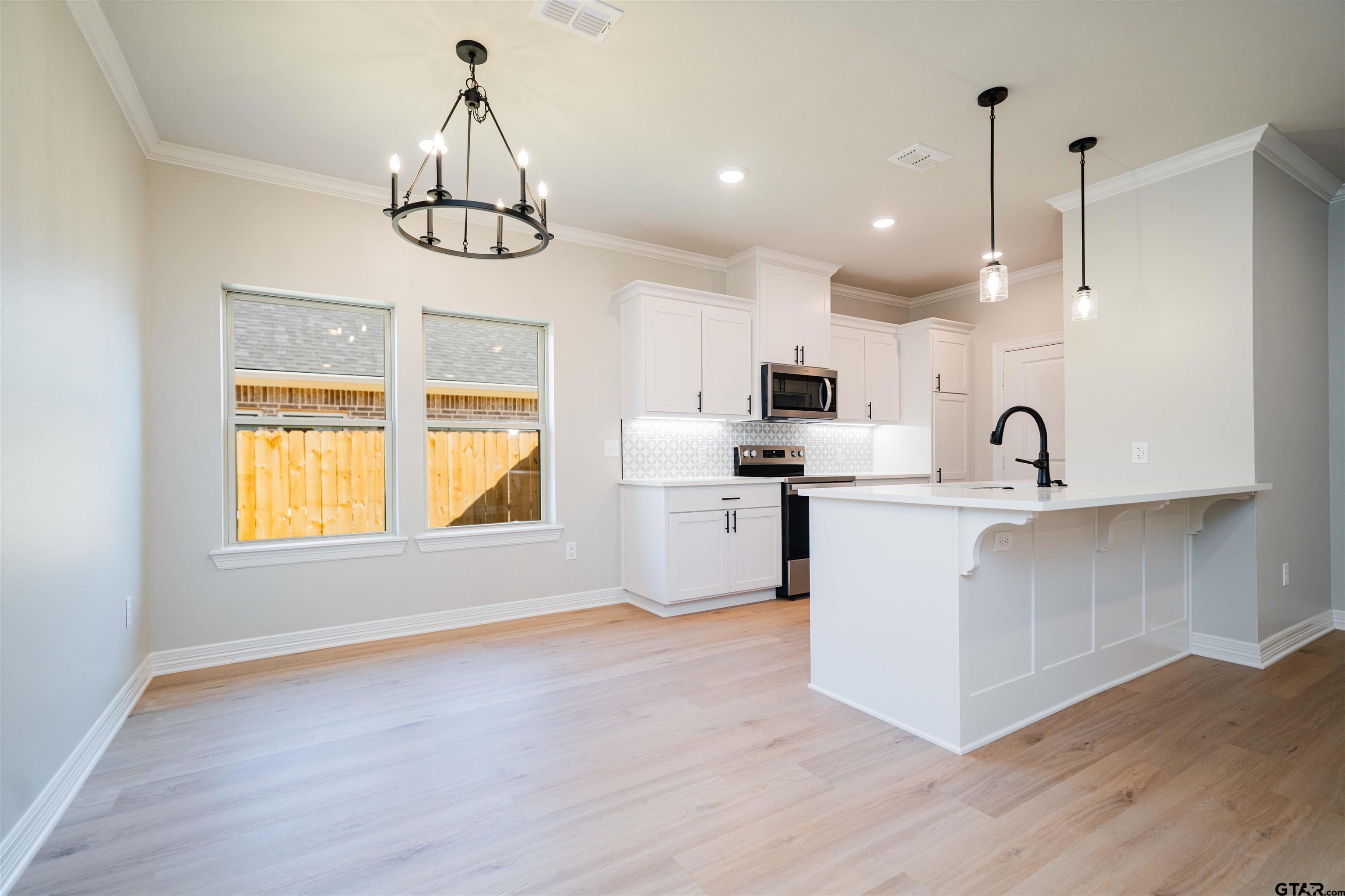 1203 Penny Lane Kilgore, TX 75662 - Photo 5 of 24 a kitchen with refrigerator and window