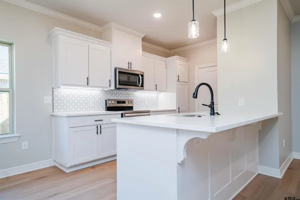 a kitchen with a sink stainless steel appliances and cabinets