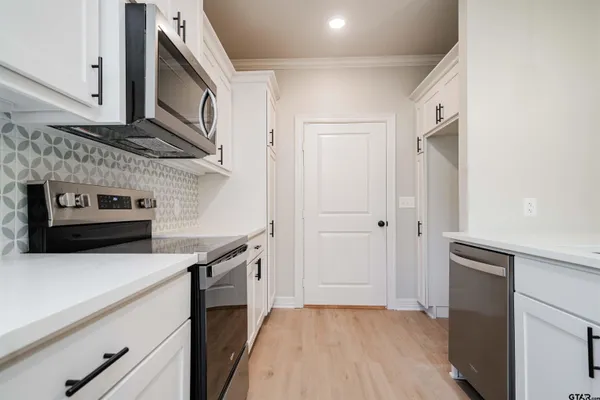 a kitchen with a stove and a microwave