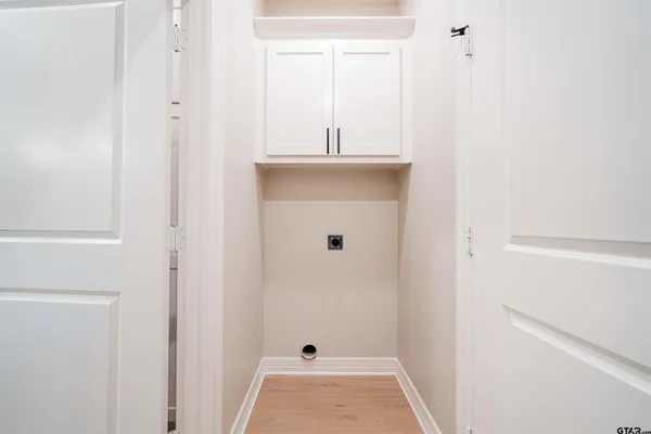 a view of empty room with wooden floor and window