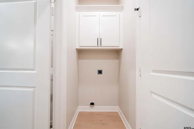 a view of empty room with wooden floor and window