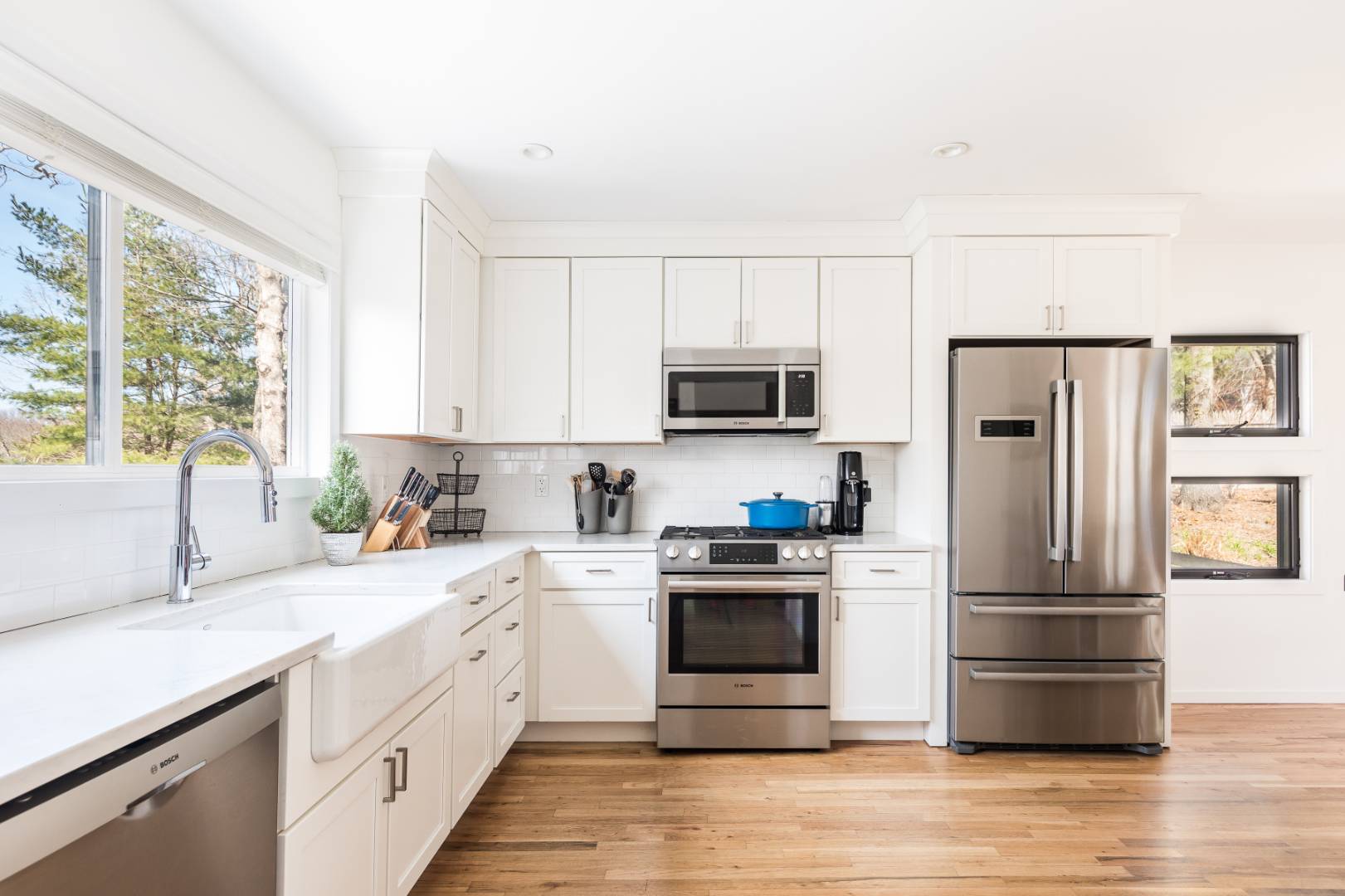 54 Johnson Avenue Southampton, NY 11968 - Photo 13 of 24 a kitchen with a refrigerator sink and wooden floor