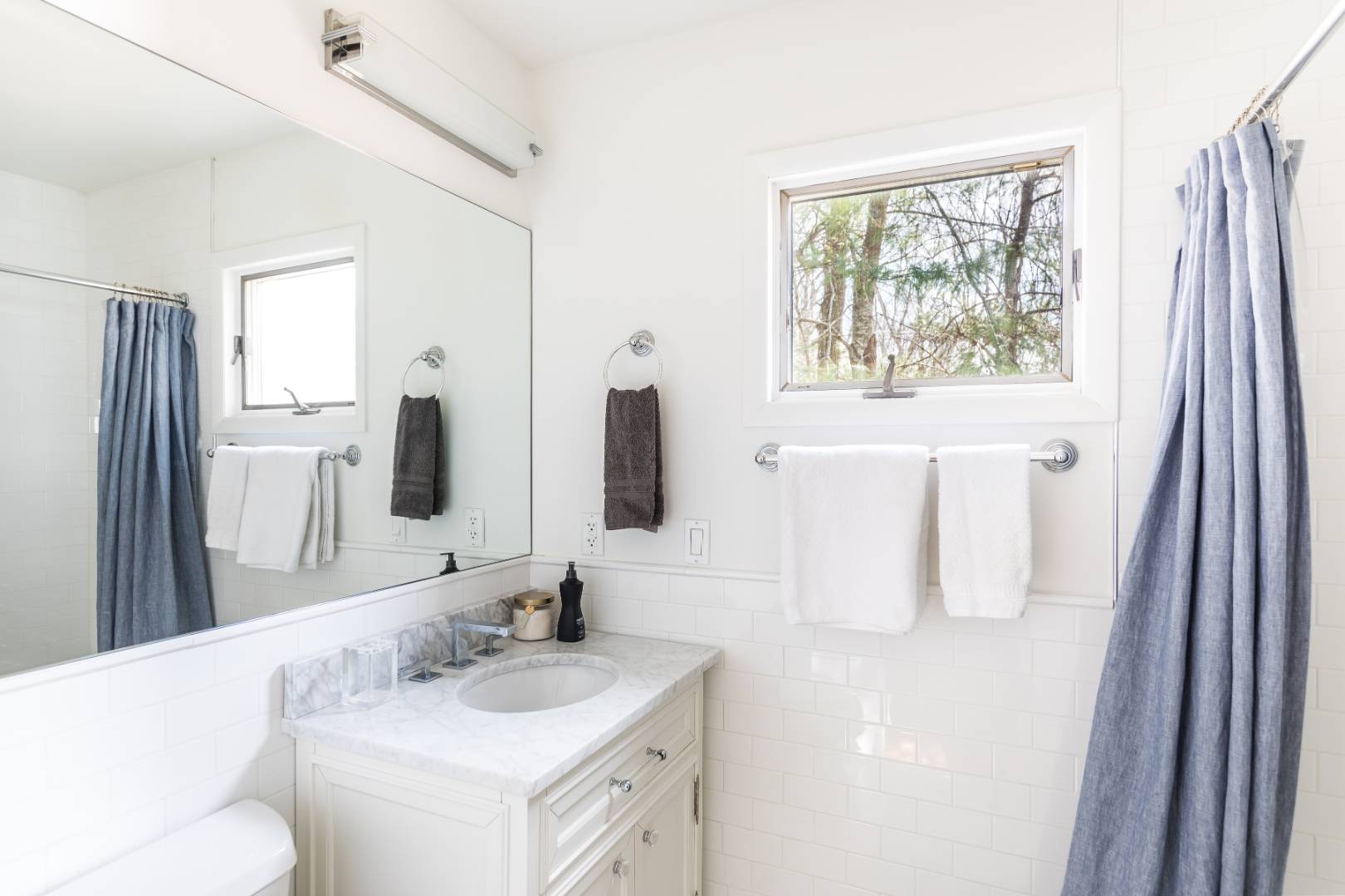54 Johnson Avenue Southampton, NY 11968 - Photo 20 of 24 a bathroom with a granite countertop sink and a mirror