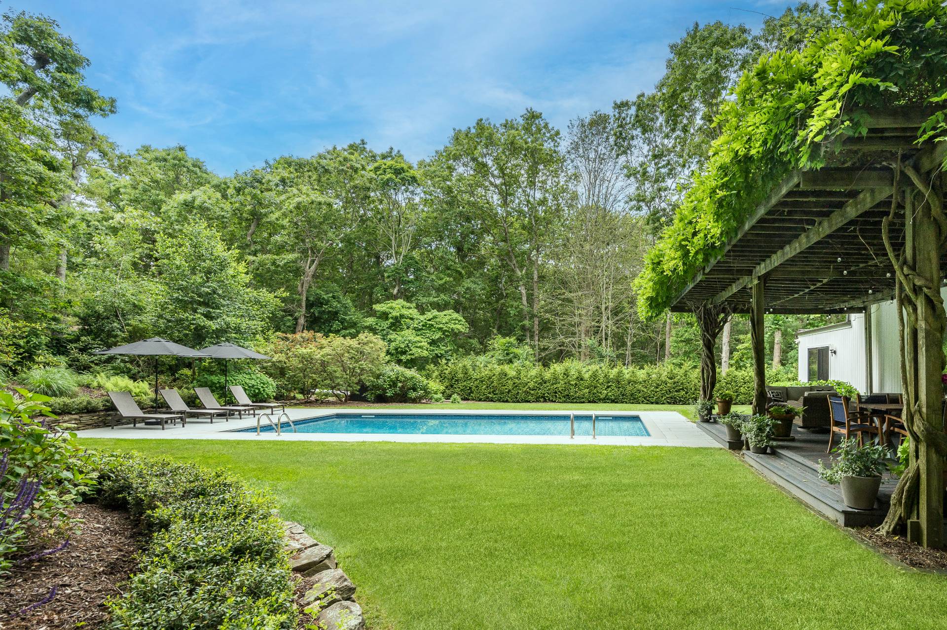54 Johnson Avenue Southampton, NY 11968 - Photo 5 of 24 a view of a swimming pool with a yard