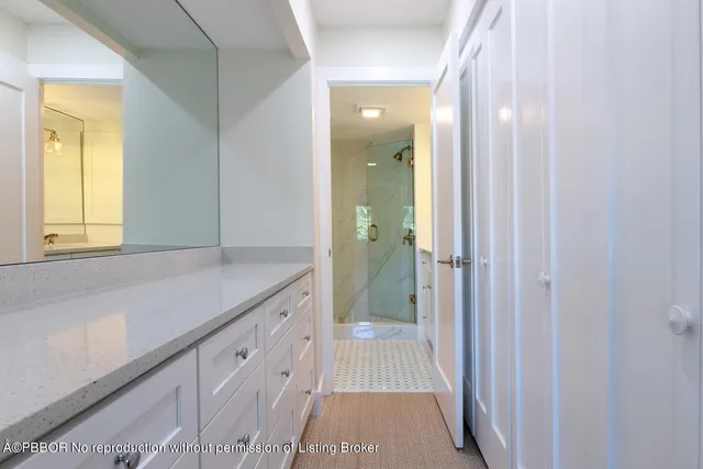 a bathroom with a sink a mirror and a shower