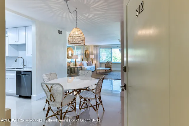 a view of a dining room with furniture and a chandelier