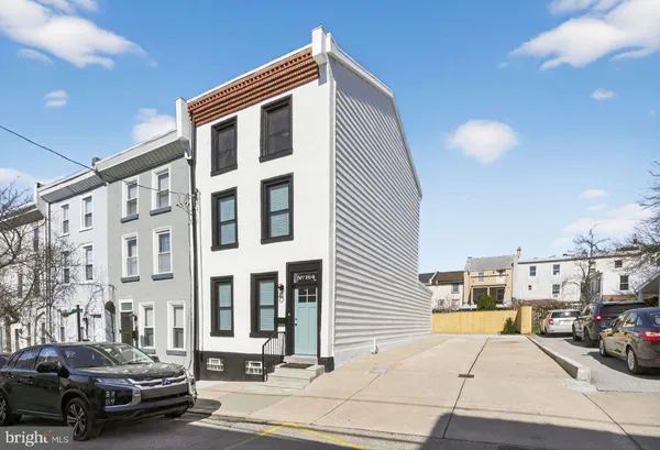 a couple of cars parked in front of a building