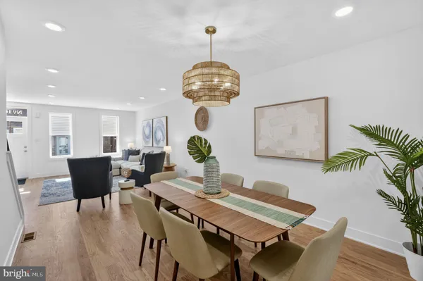 a view of a dining room with furniture wooden floor and chandelier