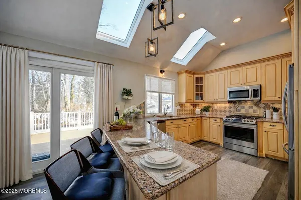 a open kitchen with sink a stove and chairs