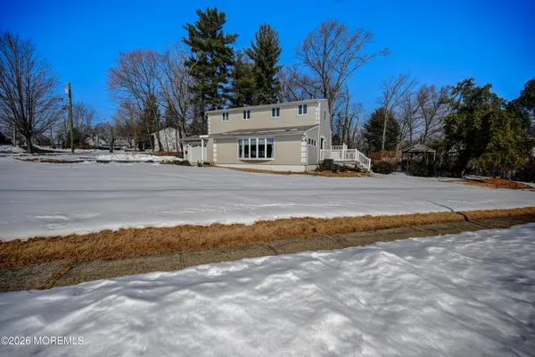 a view of a white house with a yard