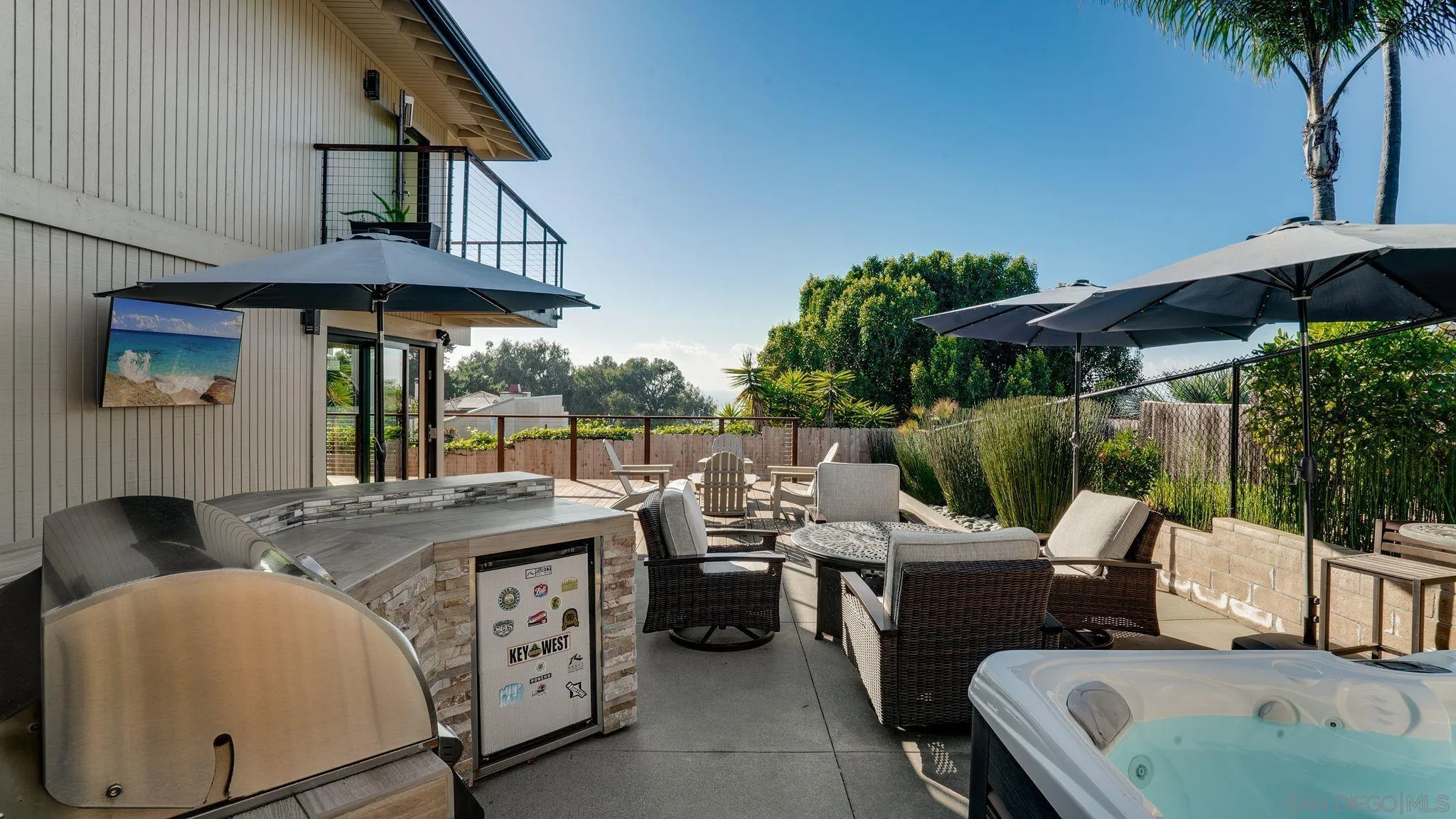 320 Del Mar Heights Road Del Mar, CA 92014 - Photo 12 of 49 a view of a patio with table and chairs under an umbrella with a small yard