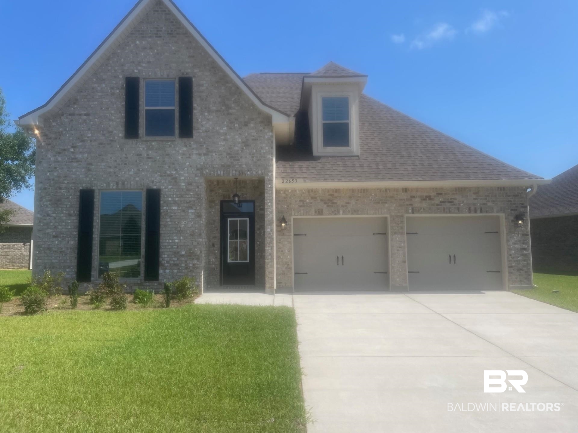 22653 Putter Lane Foley, AL 36535 - Photo 1 of 4 View of front of house featuring a garage and a front lawn