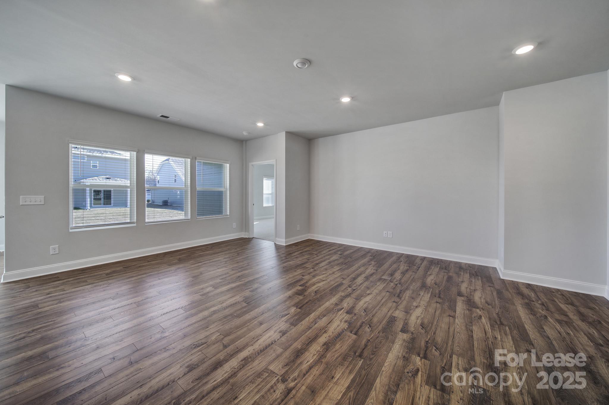 1112 Bradford Pear Road Monroe, NC 28112 - Photo 12 of 33 a view of empty room with wooden floor and fan