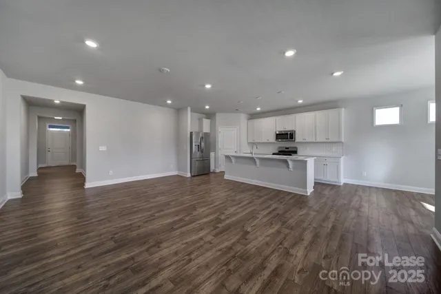 a view of kitchen with wooden floor and window