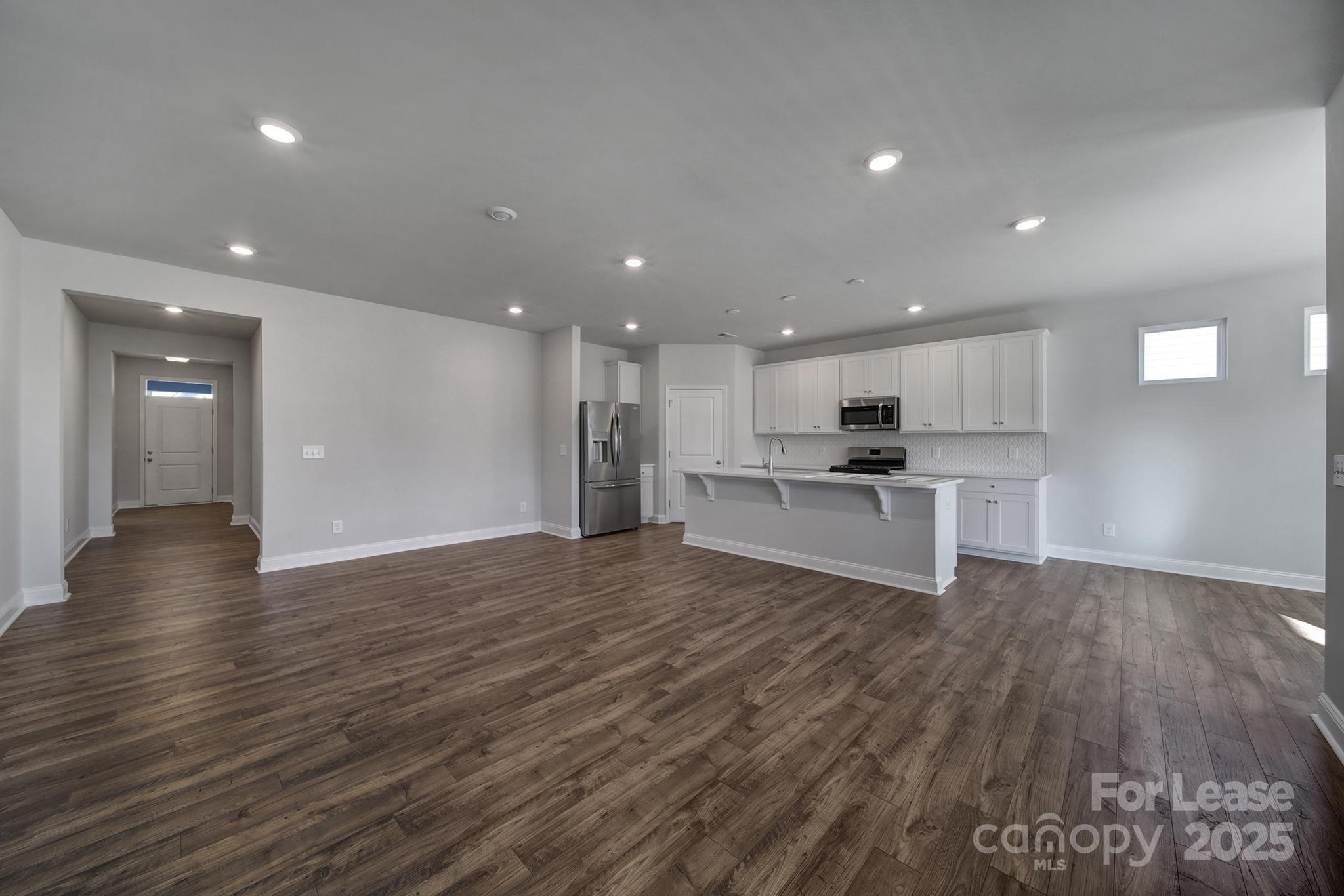 1112 Bradford Pear Road Monroe, NC 28112 - Photo 14 of 33 a view of kitchen with wooden floor and window