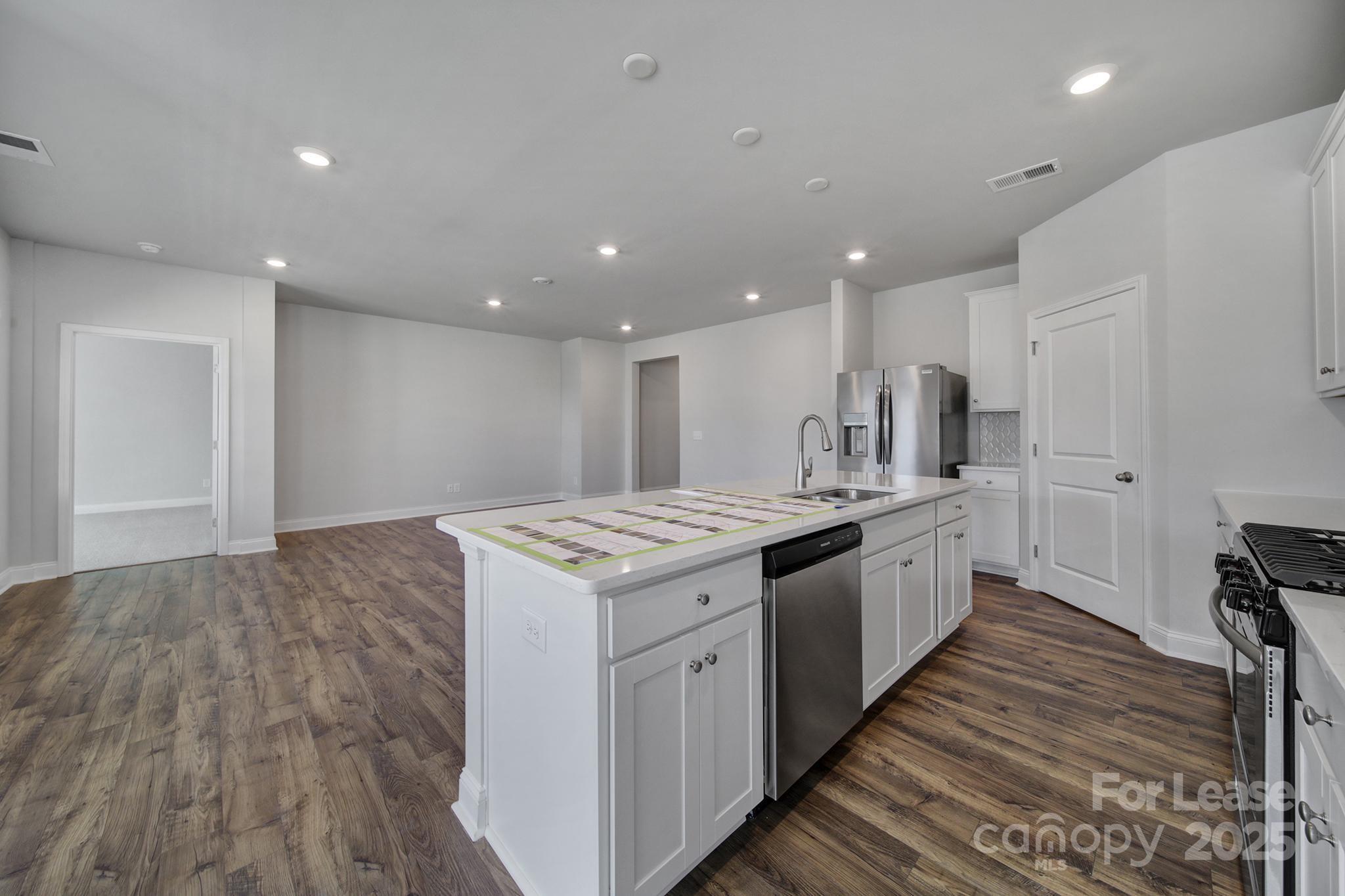 1112 Bradford Pear Road Monroe, NC 28112 - Photo 19 of 33 a kitchen with a sink and wooden floor