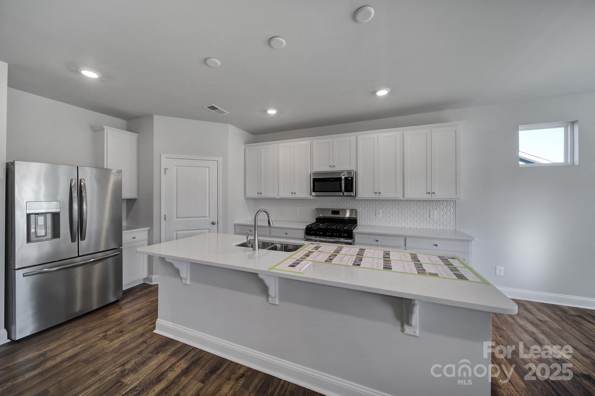 1112 Bradford Pear Road Monroe, NC 28112 - Photo 20 of 33 a kitchen that has a sink cabinets counter space and stainless steel appliances