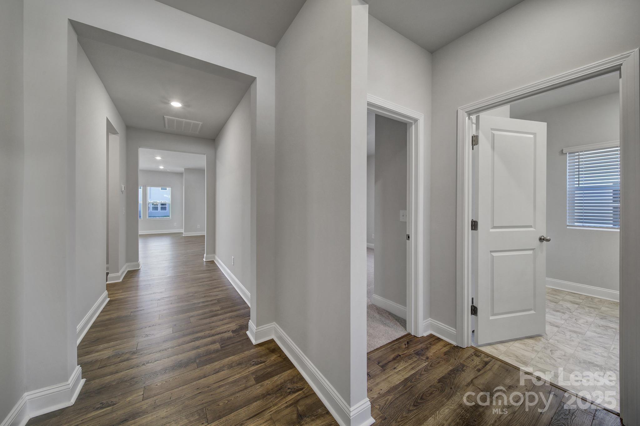 1112 Bradford Pear Road Monroe, NC 28112 - Photo 2 of 33 a view of a hallway with wooden floor and staircase