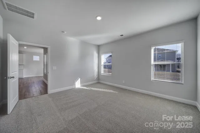 an empty room with windows and closet