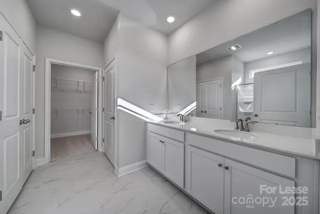 a bathroom with a double vanity sink and a mirror