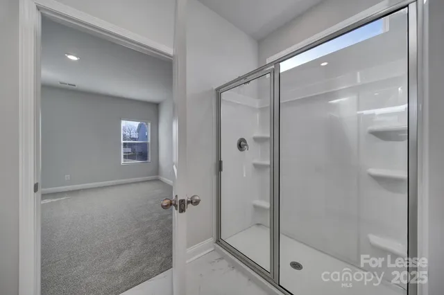 a bathroom with a glass shower door