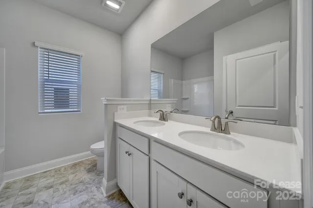 a bathroom with a sink a vanity and a mirror