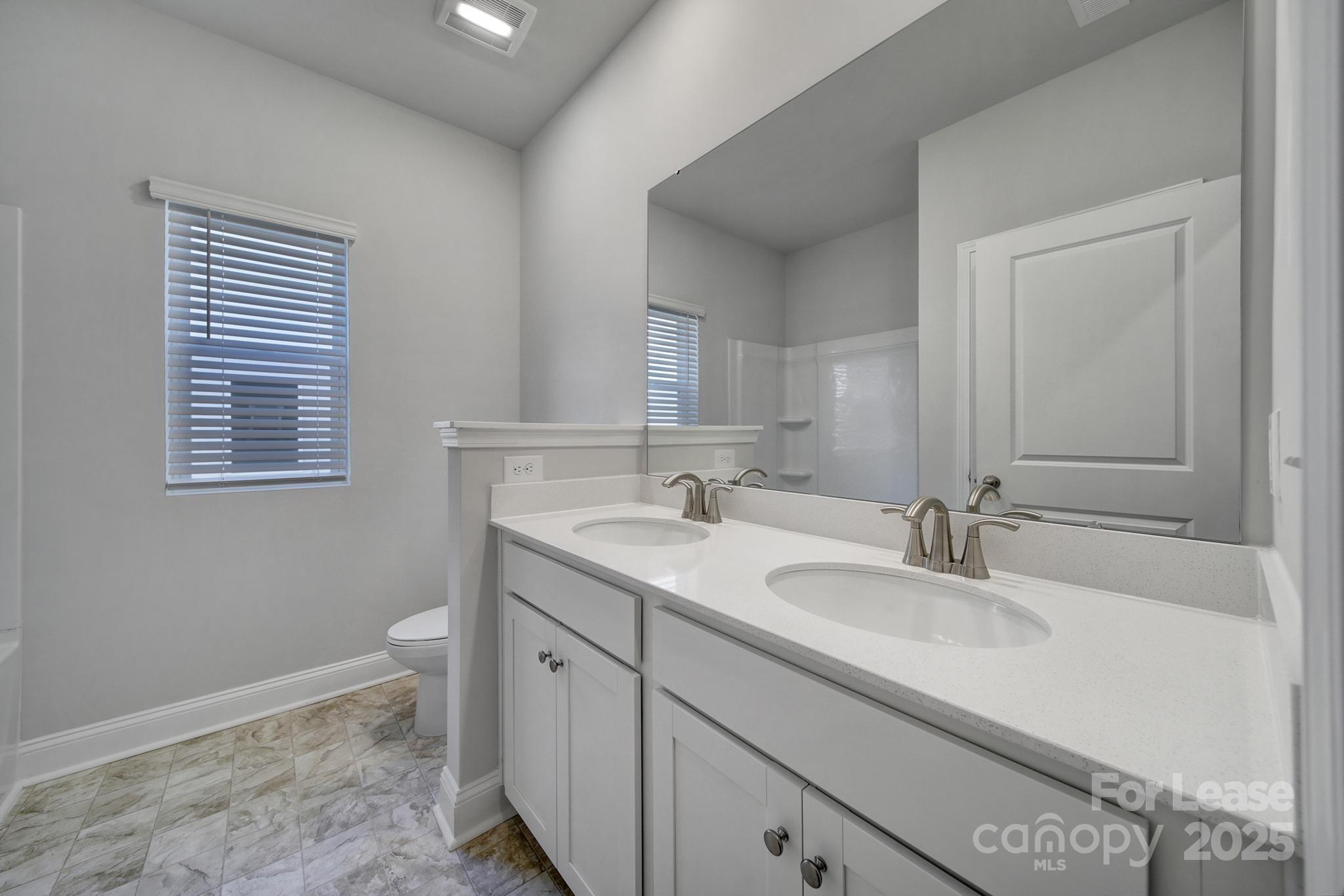 1112 Bradford Pear Road Monroe, NC 28112 - Photo 5 of 33 a bathroom with a sink a vanity and a mirror