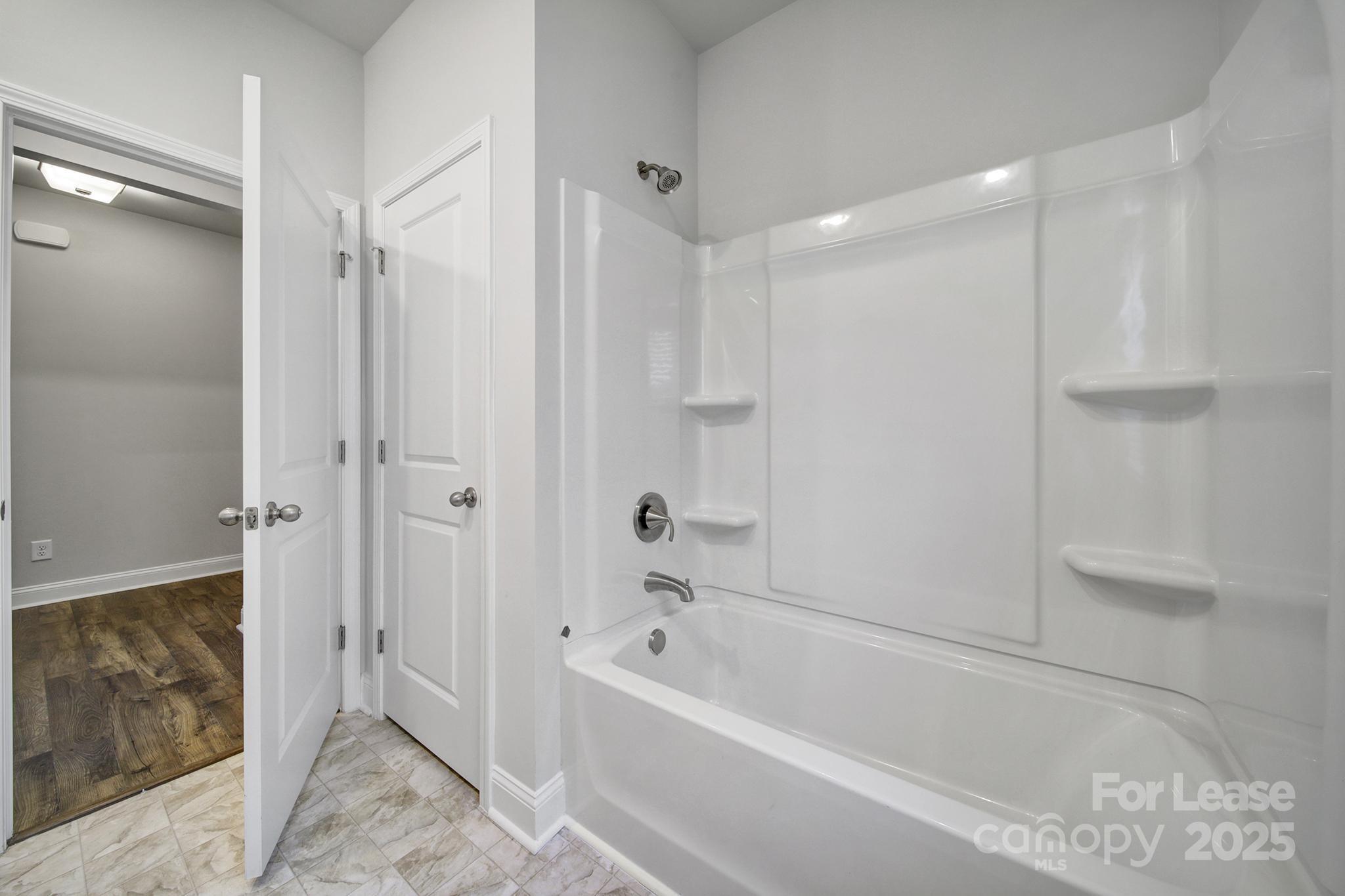 1112 Bradford Pear Road Monroe, NC 28112 - Photo 6 of 33 a bathroom with a bathtub and a shower